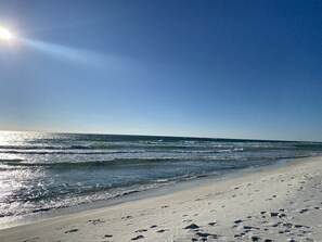 A beach with footprints in the sand and a clear sky. - Brand New & Less than 400 ft from Beach. Pet Friendly!
(Panama City Beach)