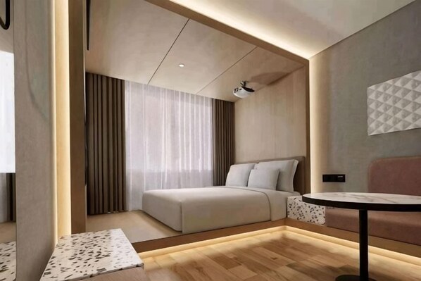 Une chambre d’hôtel moderne  équipée d’un lit, d’un canapé, d’une petite table et d’un téléviseur.