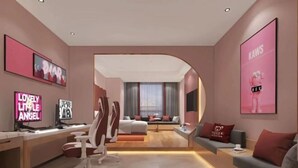 A modern hotel room with a desk, chair, sofa, and a large window. - Mushang hotel (Yiyang)