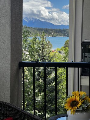 A balcony with a view of a lake and mountains.
