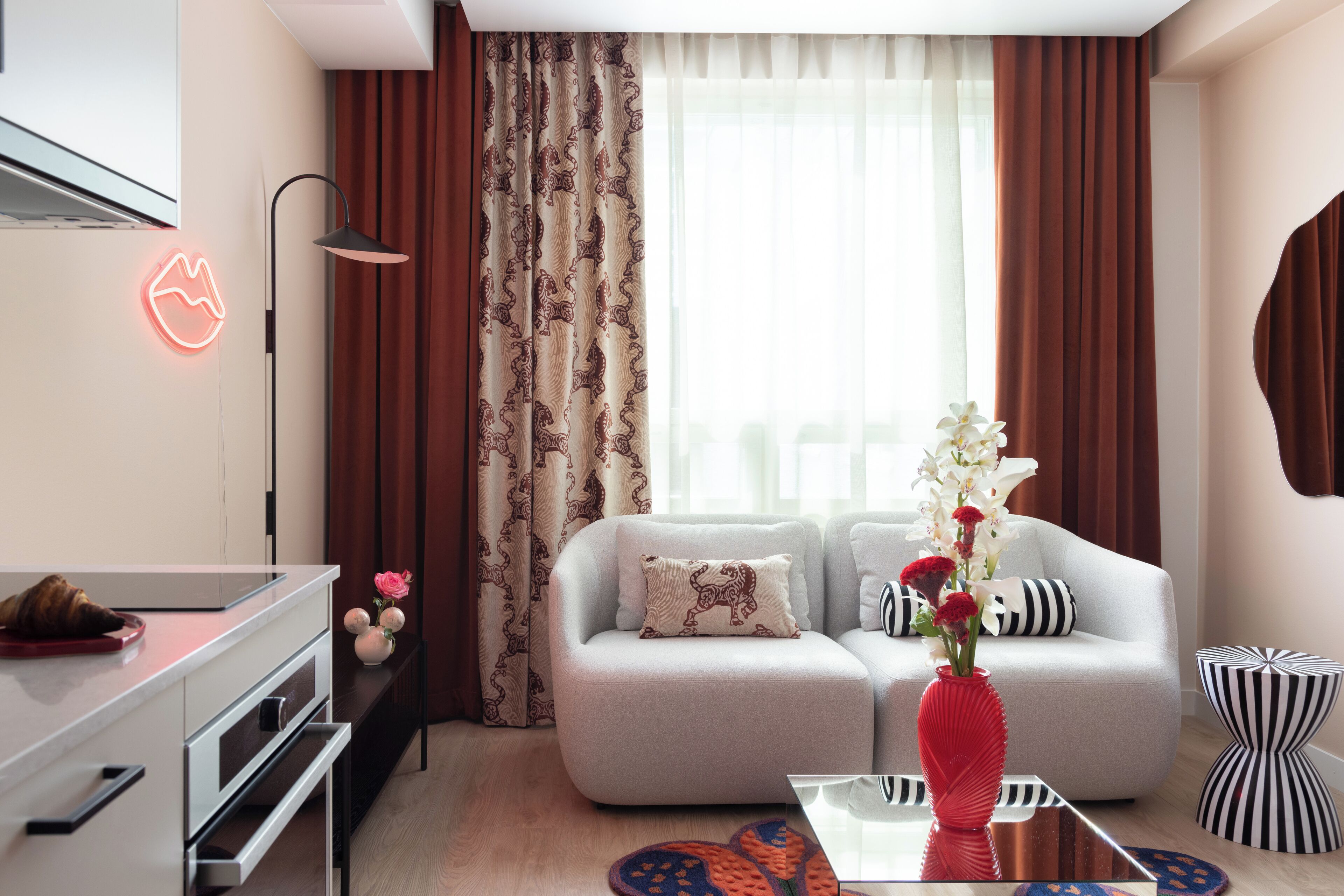 A modern living room with a sofa, a coffee table, and a decorative vase.