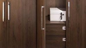 A wooden wardrobe with a mirrored closet door, a hanging rack, and a white storage box. - Chelsea Apartment | King`s Road, Sloane Sq, Lift & Underground Parking (London)