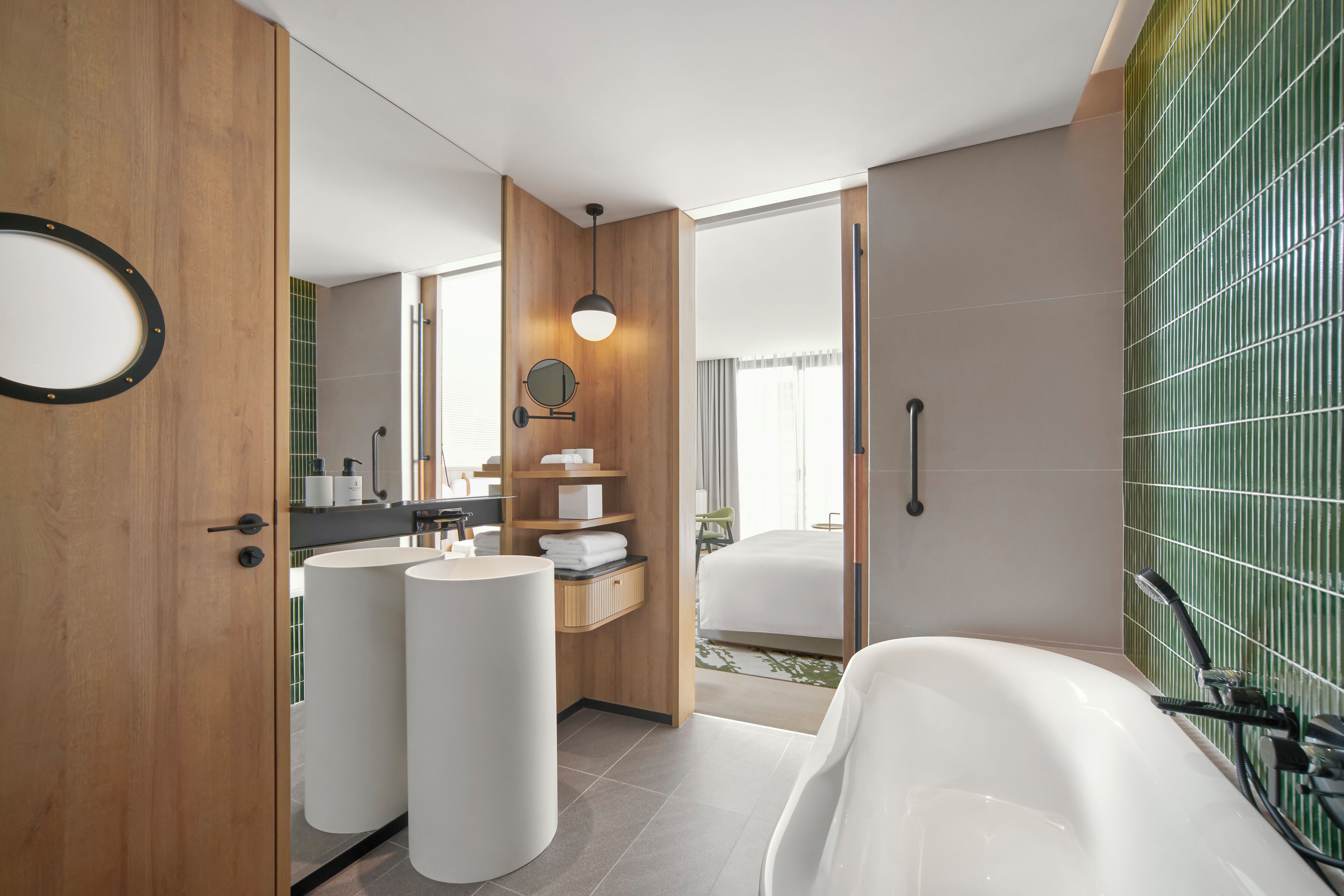 A modern bathroom with two sinks, a large bathtub, and a shower.