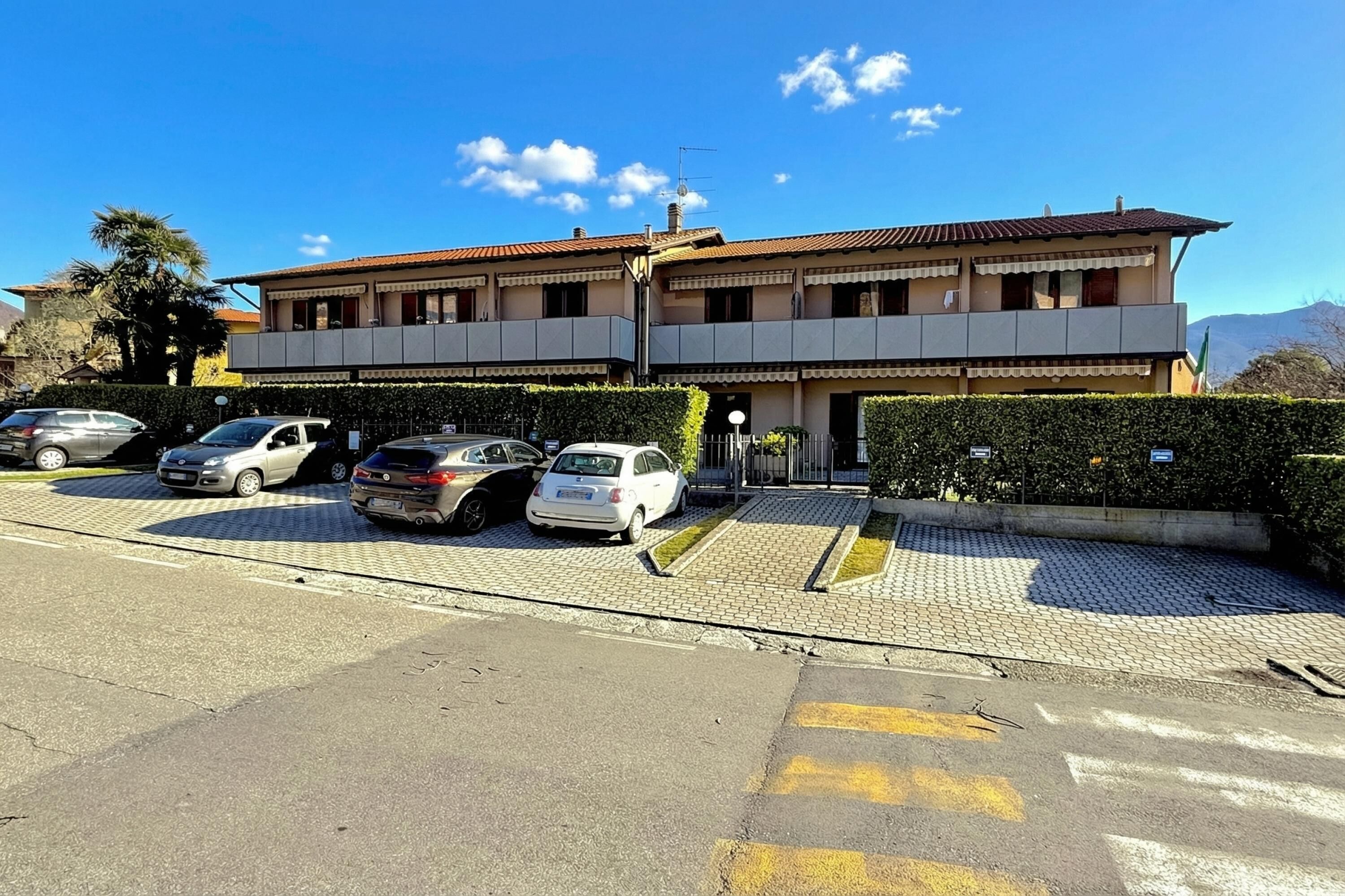 A two-story building with a parking lot in front.