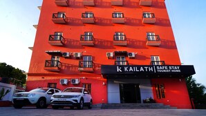 A red building with multiple balconies and a sign that reads "KAILATH Safe Stay Tourist Home." - Kailath Safe Stay Tourist Home (Tiruvalla)