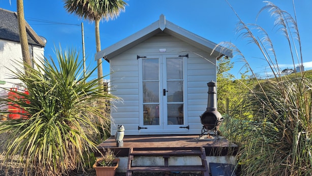 A small white building with a porch, a chimney, and a potted plant. - Beautiful 2-bed Semi Rural Cottage Enclosed Garden (Stranraer)