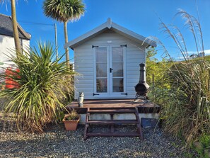 A small white building with a porch, a chimney, and a potted plant. - Beautiful 2-bed Semi Rural Cottage Enclosed Garden (Stranraer)