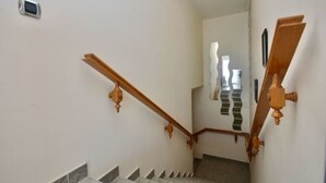A staircase with wooden handrails and a modern light fixture on the wall. - Beautiful villa  in Platja d´Aro with sea views and a pool (Platja d'Aro)