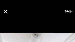 A modern bathroom with a toilet, sink, and shower area.
