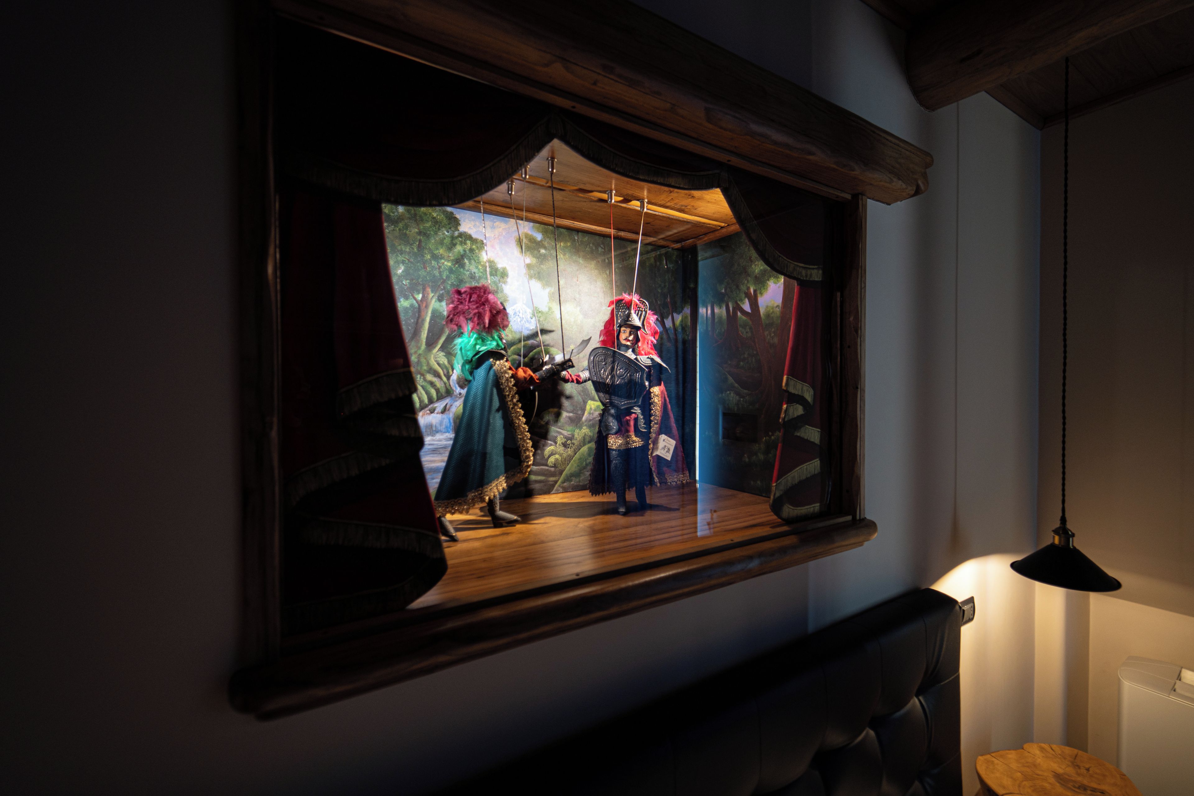 A framed display with a theatrical scene inside a window.