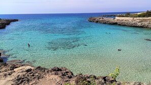A coastal landscape with clear turquoise waters, rocky shorelines, and sparse vegetation. - CASA CICCONE CARDONE , trulli with Jacuzzi  and private parking lot  (Locorotondo)