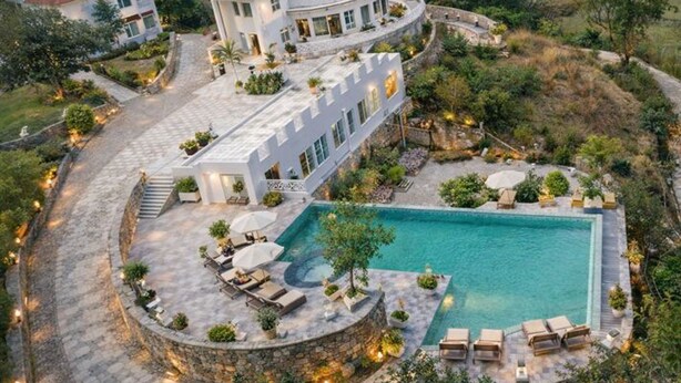 A luxurious villa with a swimming pool, outdoor seating, and a landscaped garden. - The Sky Imperial Pavoreal Jungle Resort (Kumbhalgarh)