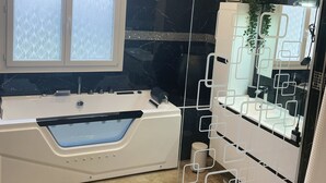 A modern bathroom with a freestanding bathtub, a glass shower enclosure, and a vanity with a mirror. - 2 steps from the lake. (Parentis-en-Born)