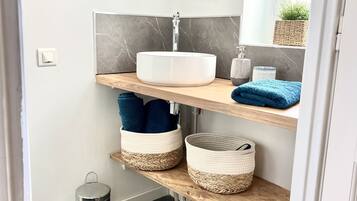 Shower, hair dryer, towels, toilet paper