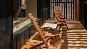 A wooden deck with two lounge chairs and a small table, overlooking a forested area. - Eastwind Oliverea Valley (Big Indian)