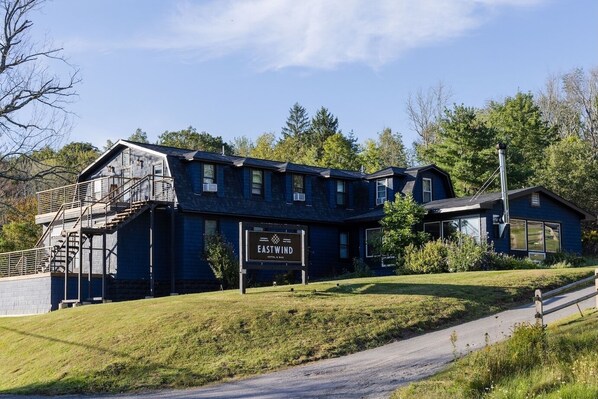 A two-story building with a sign reading "EASTWIND HOTEL & BAR".