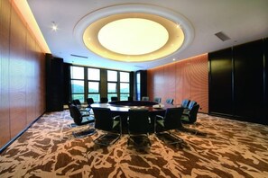 A conference room with a round table, chairs, and a large window. - Longhu Hotel (Zhaoyuan)