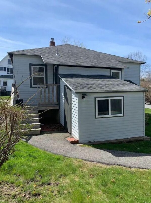 A two-story house with a small attached garage.