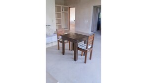 Cozy space with a dining table and seating area, perfect for relaxing and socializing.