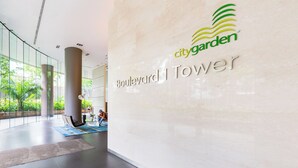 A modern interior with a glass wall, a logo for 'citygarden', and a sign reading 'Boulevard Tower'. - An Corner City Garden High Class Condo (Ho Chi Minh City)