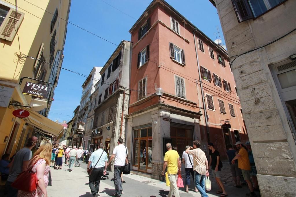 A street scene with pedestrians and buildings.