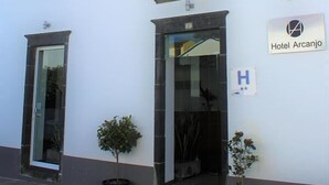 A two-story building with a sign reading "Hotel Arcanjo." - Arcangel Hotel (Lagoa)