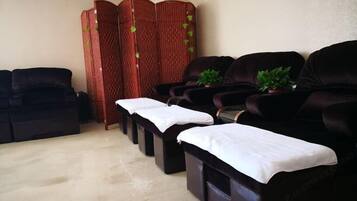 Relax in comfort with our massage therapy chairs, each draped in a soft cloth, surrounded by lush greenery and a soothing atmosphere.