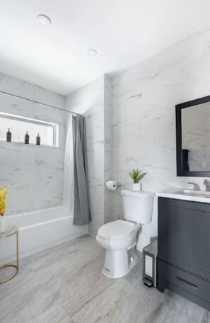 A modern bathroom with a toilet, sink, and shower. - Luxury 3Bed Private Apartment with parking  (New Rochelle)