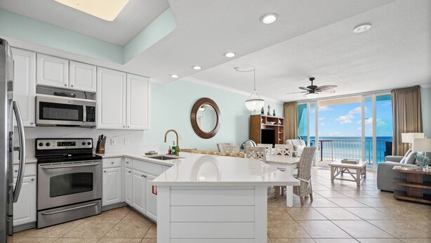 A modern kitchen with white cabinetry, a built-in oven, and a microwave. - Luxury Beachfront condo - 3 Bedroom, 3 full Bath, 2 master suites, sleeps 8. (Gulf Shores)
