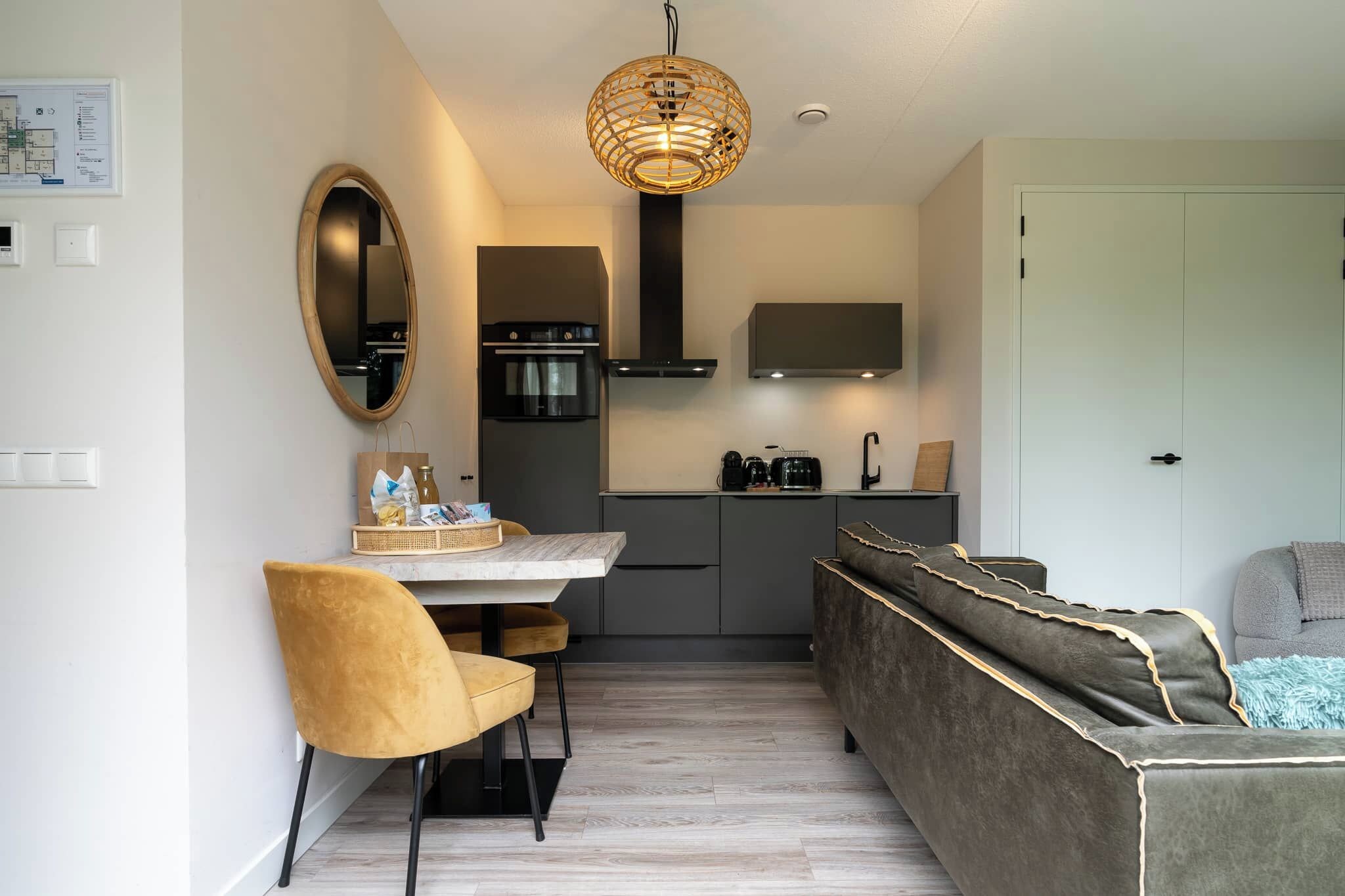 A compact living space with a dining area, kitchenette, and seating area.