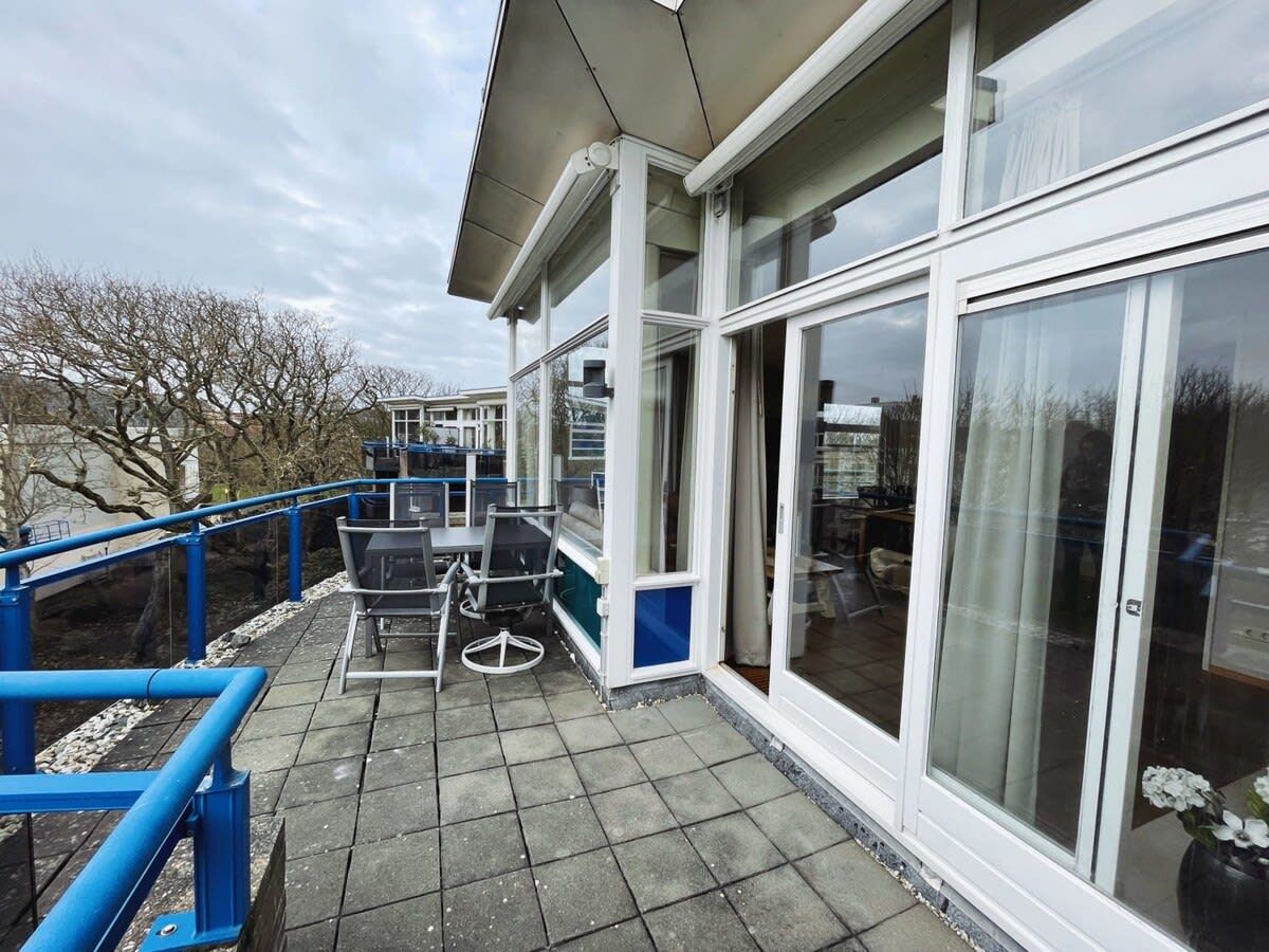 Un balcon doté de mobilier d’extérieur, d’une balustrade et offrant une vue sur les environs.