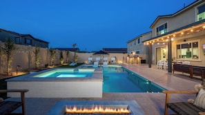 A backyard with a swimming pool, outdoor seating, and a fire pit. - 2 Mi. To Coachella Festival - Pool, Spa, Gameroom (Coachella)