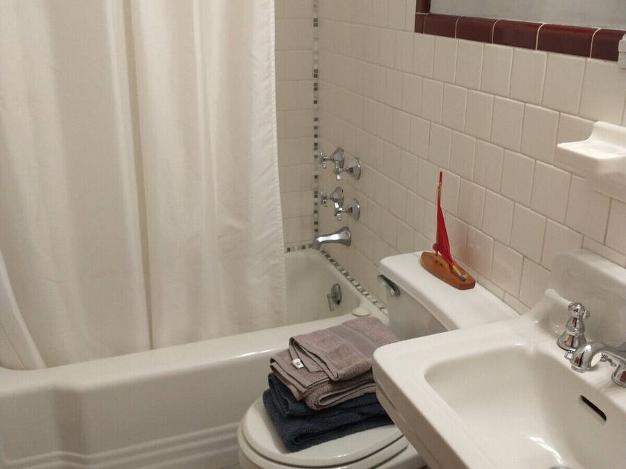 A bathroom with a bathtub, toilet, and sink.