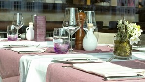A dining table set with wine glasses, a salt and pepper shaker, a small vase with flowers, and a candle holder. - Apartment top location in Tiergarten, directly on the Spree, near Bellevue S-Bahn. (Berlin)