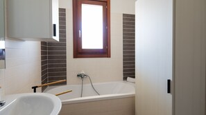 Bathtub, hair dryer, bidet, towels