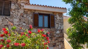 A stone building with a tiled roof and shutters. - Casa della Luna - One Bedroom Apartment, Sleeps 3 (Agrustos)