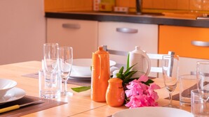 A dining table set with clear glasses, plates, and a white teapot. - L'Alzoni - Two Bedroom House, Sleeps 5 (L'alzoni)