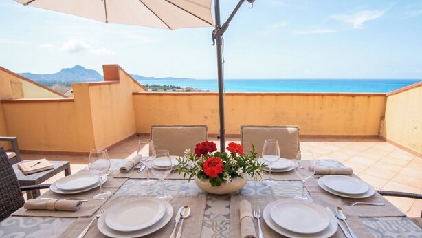 A table set for dining with a view of the sea and mountains. - Villa Paola - Panoramic Seaview Terrace (Costa Rei)