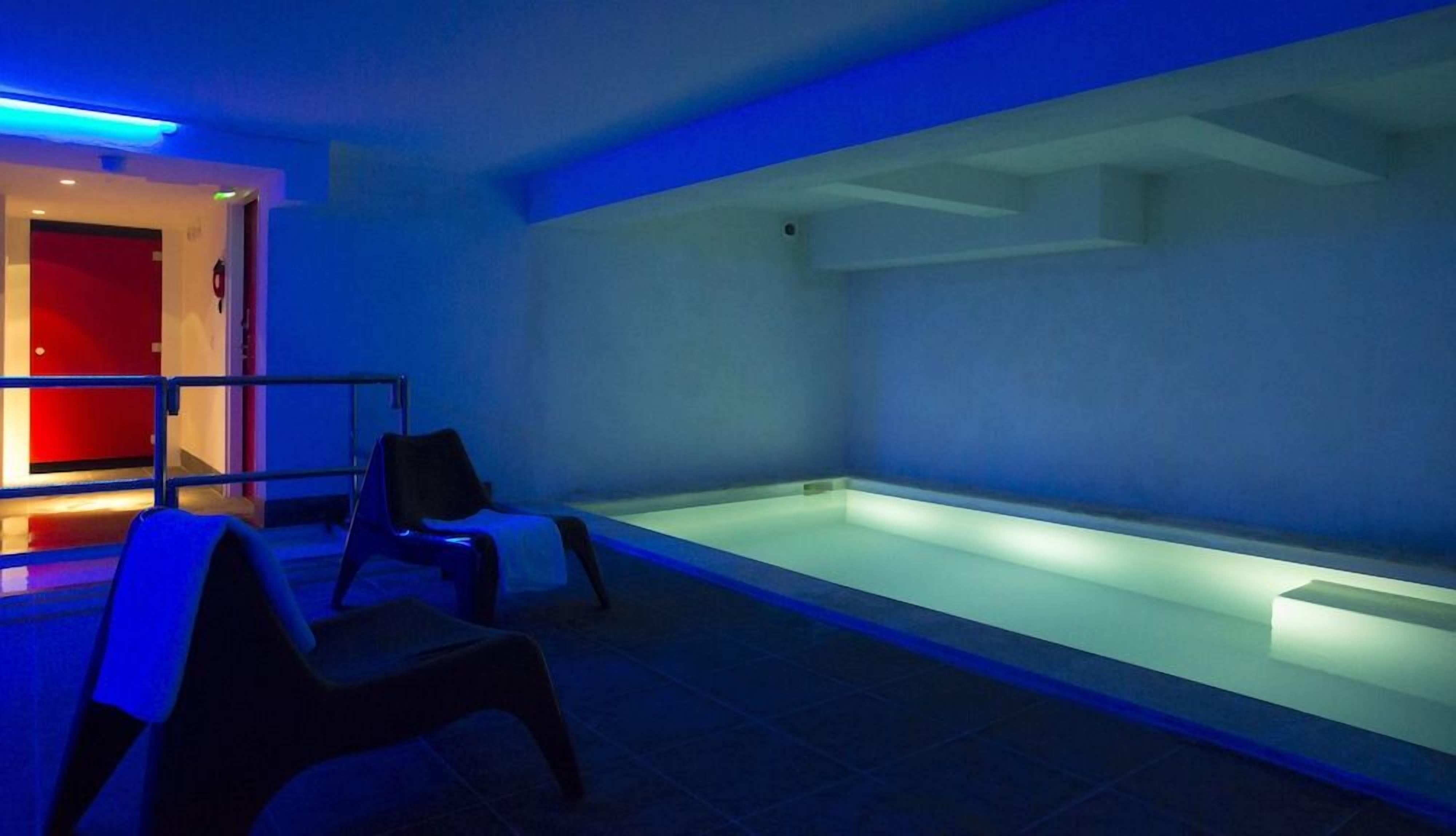 A room with a heated floor, a red door, and a blue-lit reception area.