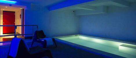 A room with a heated floor, a red door, and a blue-lit reception area.