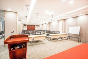 A conference room with a long table, a podium, and a whiteboard. - Xi . Hotel (Huidong)