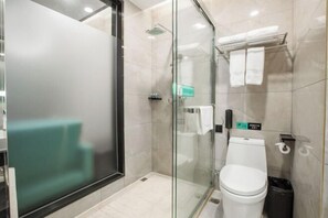A modern bathroom with a glass-enclosed shower, a toilet, and a towel rack. - Xi . Hotel (Huidong)