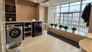 A modern bathroom with a large window, a sink, and a mirror. - Vienna Hotel (Taihe Chengjiang Avenue) (Taihe)