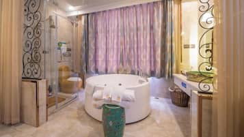 A modern bathroom with a freestanding bathtub, a glass shower enclosure, and a vanity with a mirror.
