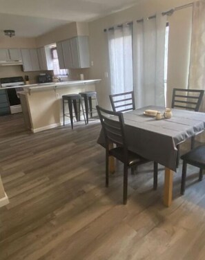 Enjoy a compact living space with a kitchen and dining area, featuring modern appliances and a combined open layout.
