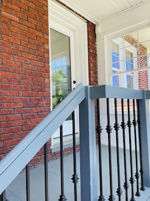Staircase leads to a landing adjacent to a door.