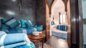 Una habitación acogedora con un conjunto de sofás, una mesita y un tapete estampado.