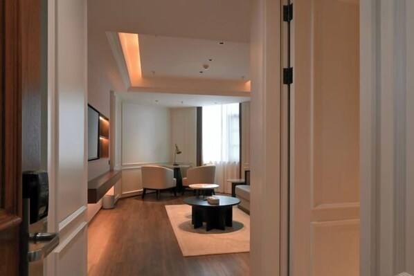 A modern living room with a sofa, coffee table, and a TV.