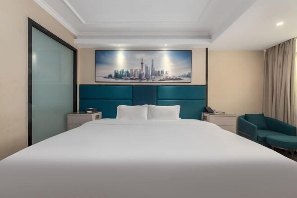 A hotel room with a large bed, a cityscape painting on the wall, a teal headboard, and a nightstand with a phone. - Country Inn & Suites by Radisson, Dongguan Houjie Wanda Plaza (Dongguan)