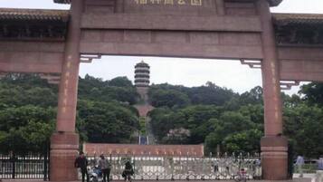A traditional Chinese gate with a pagoda in the background.